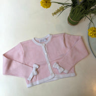 Bolero rosado con lazos en puños